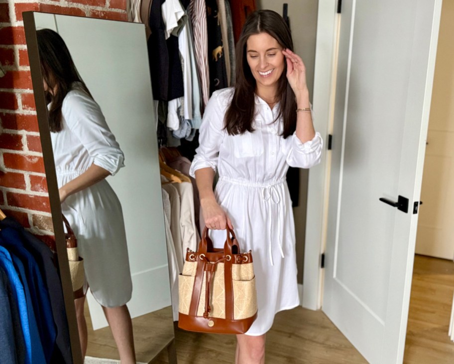 woman in white dress holding bucket bag