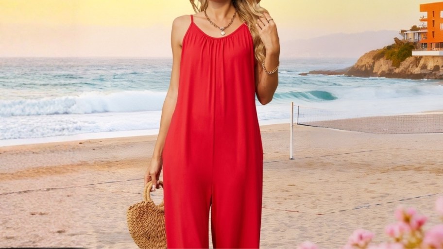 a woman on the beach in a red romper