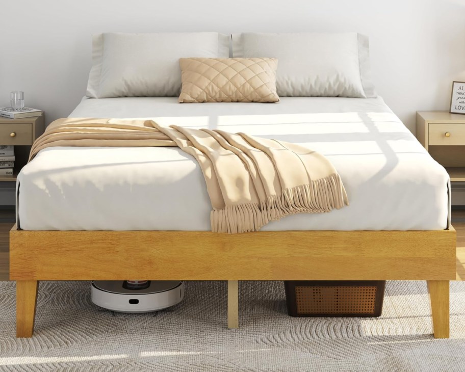 mattress on natural wood bed frame