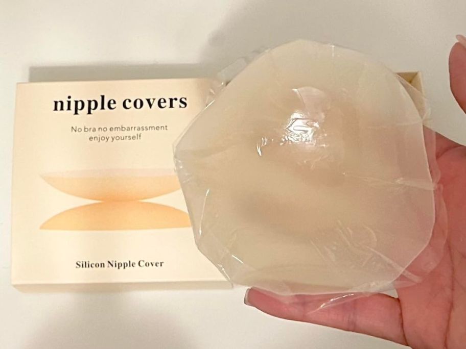 A person holding a nipple cover