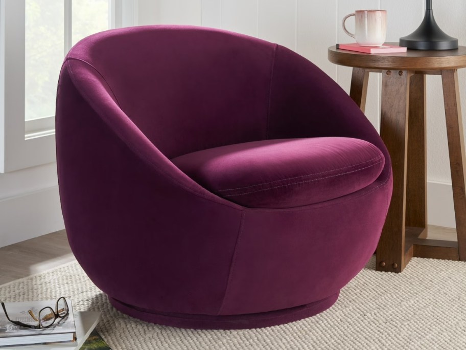 Better Homes & Gardens Mira Swivel Accent Chair in purple sitting in living room with accent table