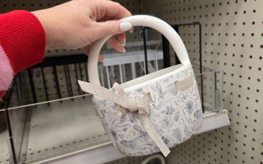 hand holding ceramic basket in easter print