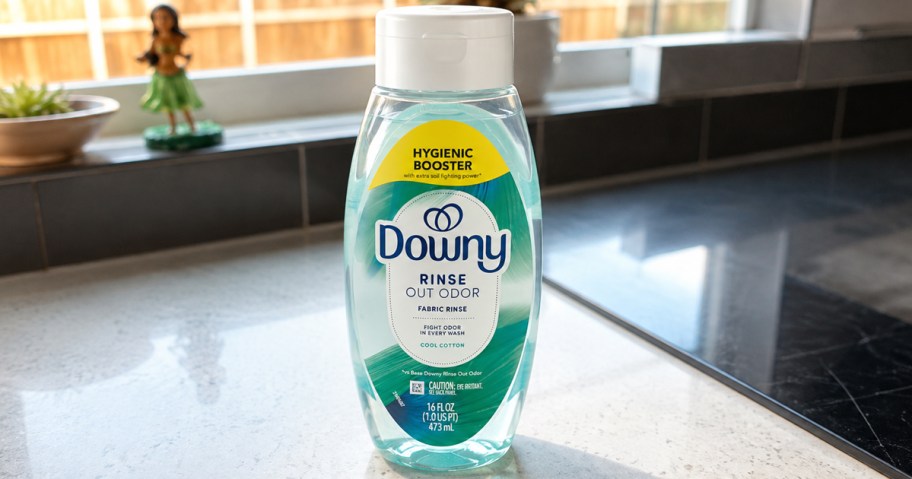 small bottle of Downy Rinse Out Odor on counter