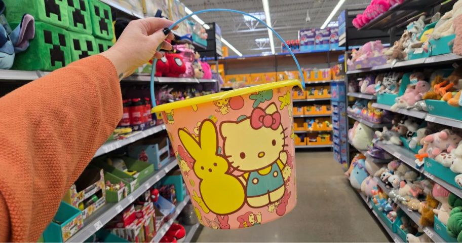 A person holding a Hello Kitty Easter Bucket at Walmart