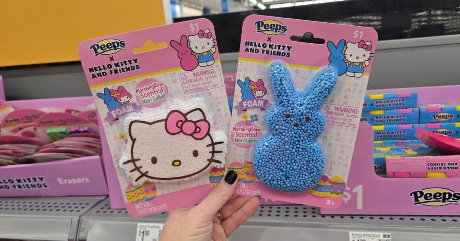 A person holding two Hello Kitty x Peeps Easter Foam toys at Walmart