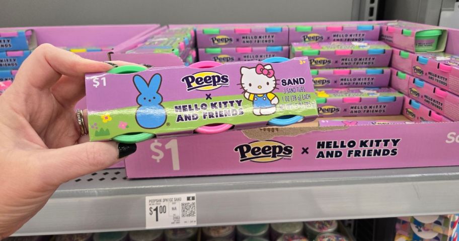 A person holding a pack of Hello Kitty x Peeps Easter Sand at Walmart