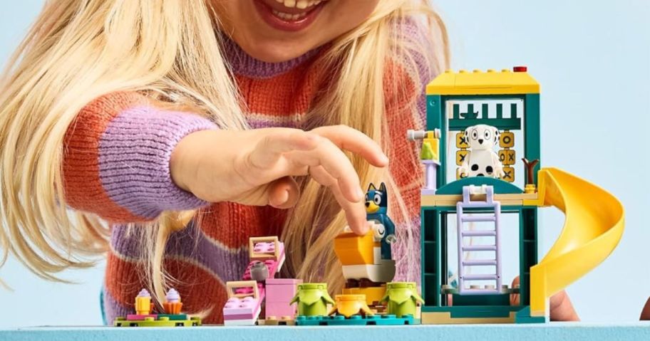 Little Girl Playing with a Bluey Lego Set