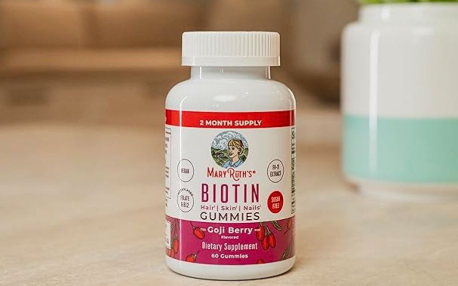 a bottle of biotin gummies on a counter top