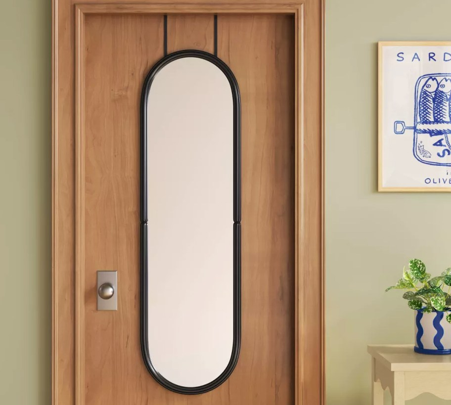 oval shaped mirror on the back of a door