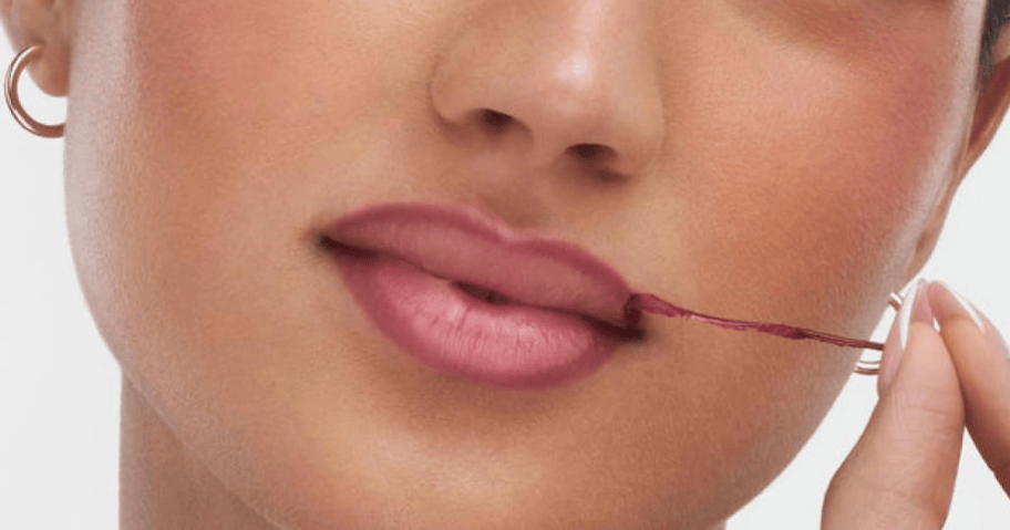 woman peeling off lip stain