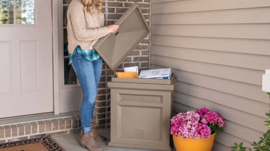 a woman lifting the lid off a parcel delivery box