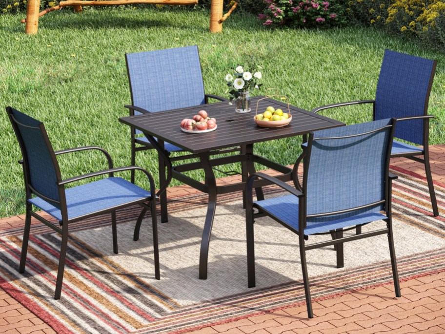 black patio table with 4 blue chairs