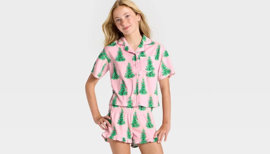 girl posing in pink and green tree pajamas