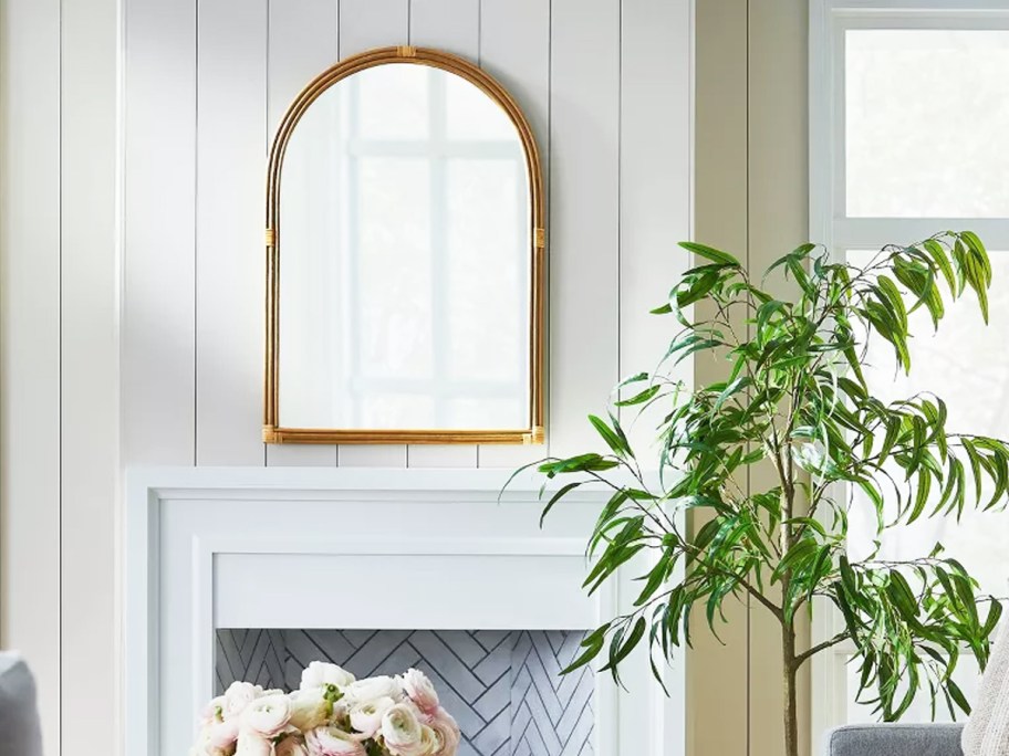 arched wall mirror above mantel