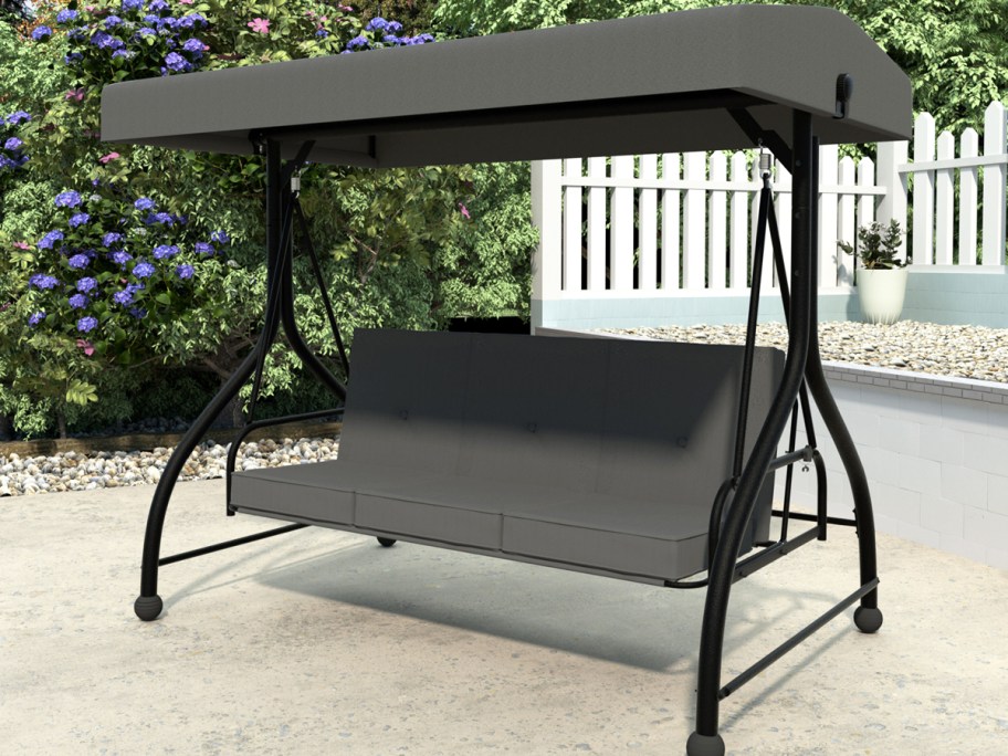 grey patio swing with matching shade cover
