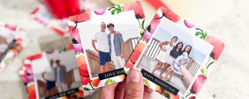 hand holding two colorful photo coasters