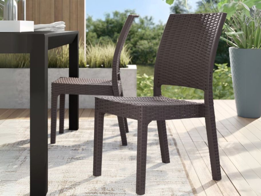 Wildon Home Tomosuke Outdoor Stacking Chair 2-Piece on patio next to table