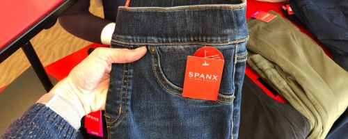 Woman holding Spanx jeans