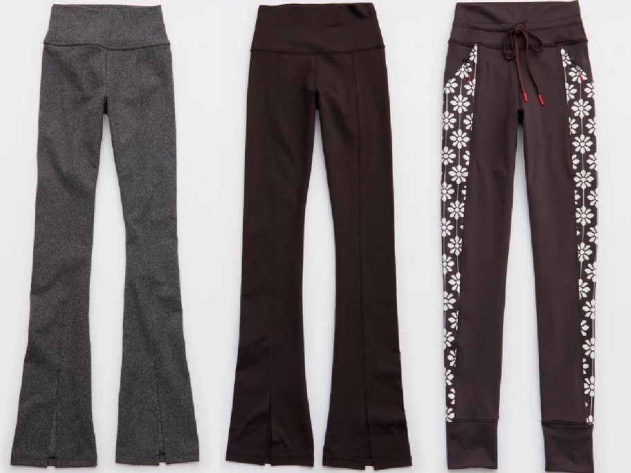 Three pairs of women's workout leggings in different styles and colors: one gray with a flared bottom, one solid black, and one black with white floral designs down the side.