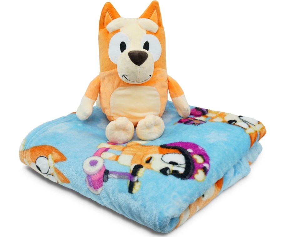 a bingo plush toy on a folded blanket