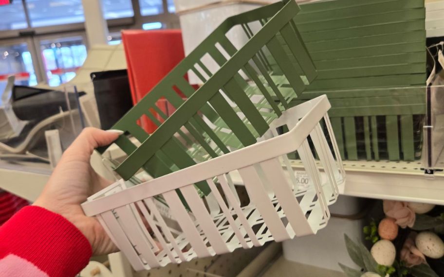hand holding color baskets in white and green