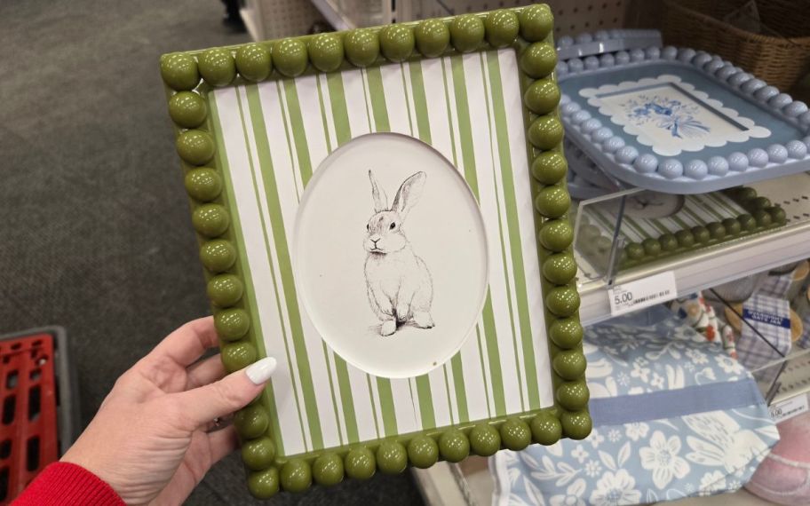 hand holding easter frame in green with a bunny inside