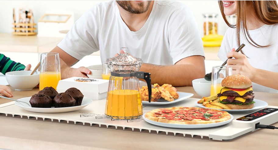 family eating at table with food warming mat