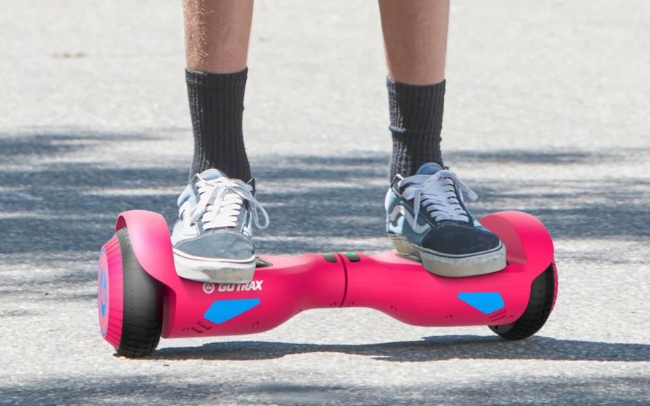 a mans feet as he stands on a hoverboard