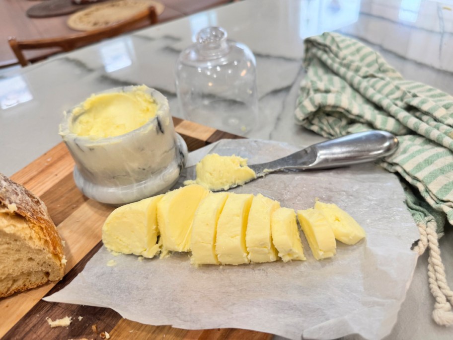 homemade butter cut into slices on parchment paper