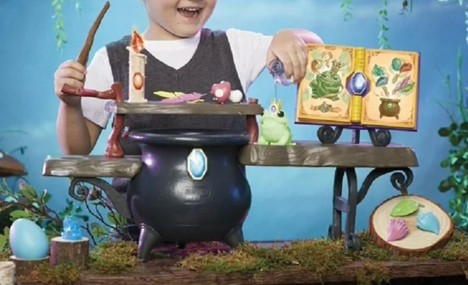 child playing with little tikes magic workshop toy 