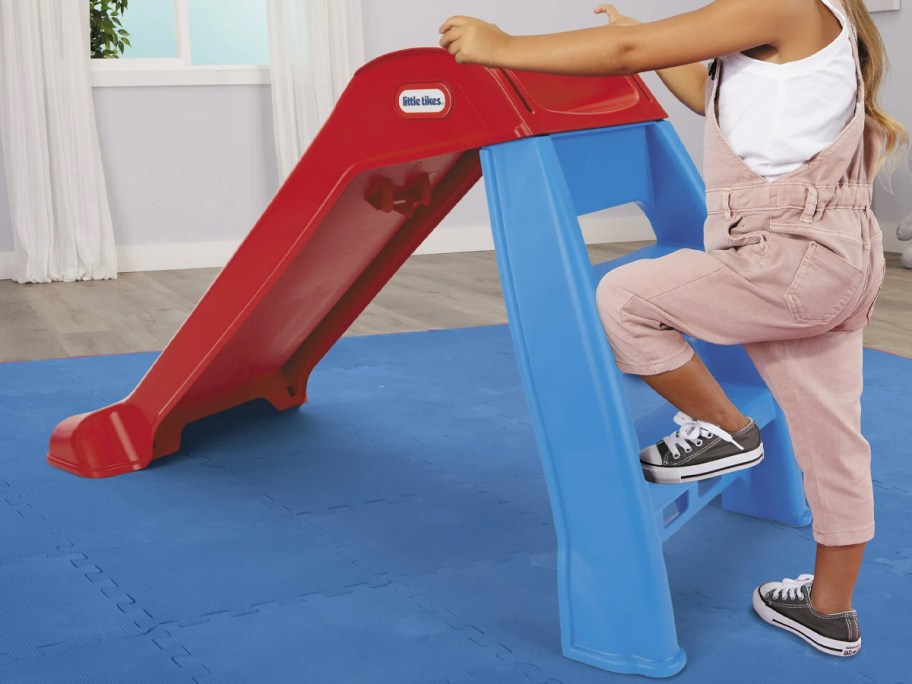 child climbing red and blue little tikes slide 