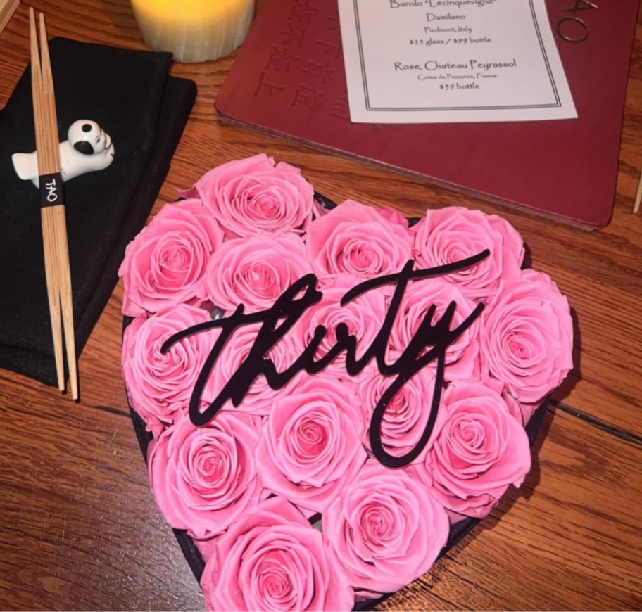 a heart shaped box of pink roses