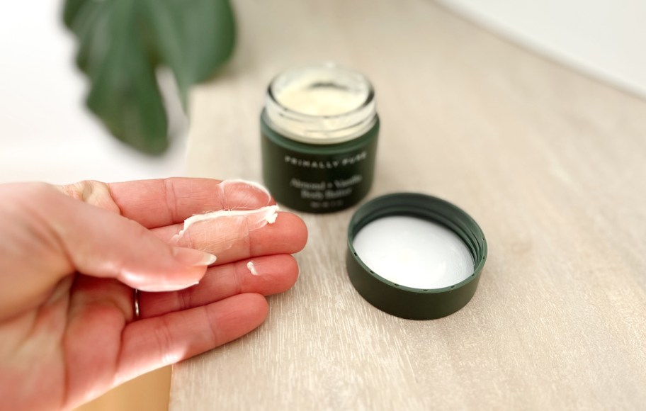 hand with body butter on fingertips 