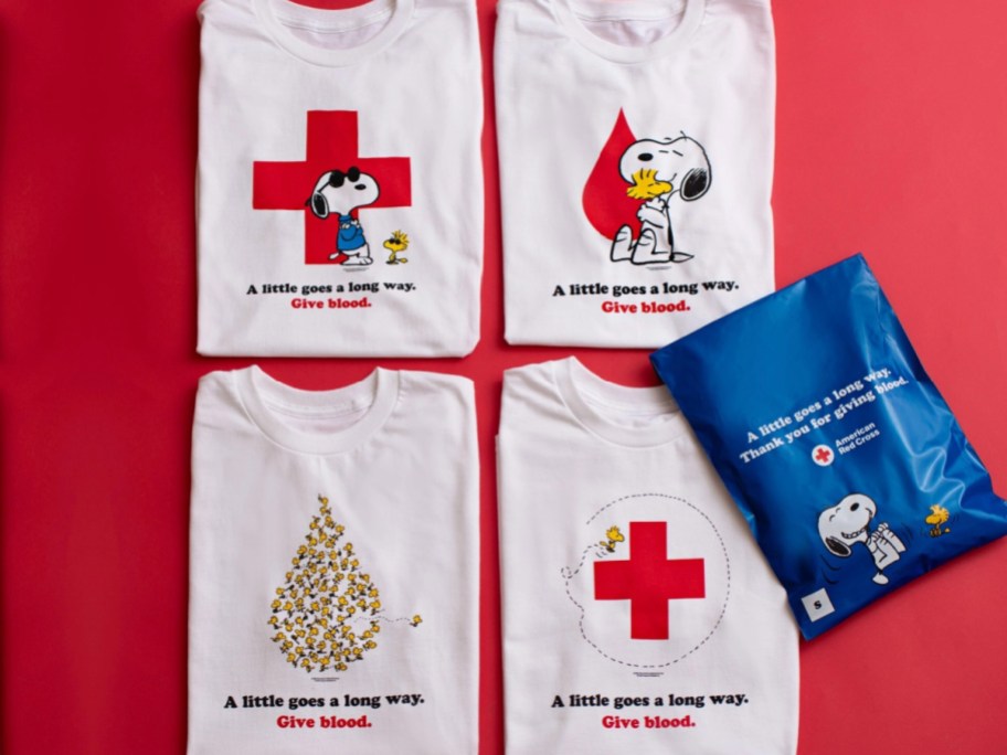 snoopy and peanuts on four red cross shirts