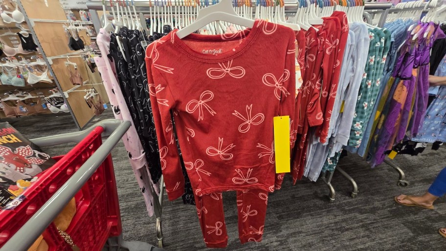 set of red bow pajamas hanging in target store