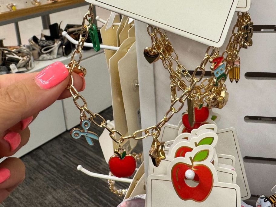 Teacher Apple Pencil Scissor Charm Bracelet in hand in store