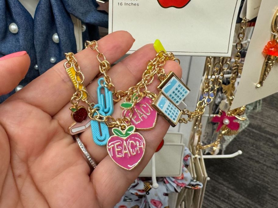 Teacher Pencil Calculator Apple Charm Necklace in hand in store