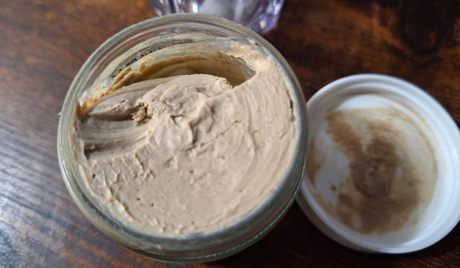 close up of toothpaste in glass jar