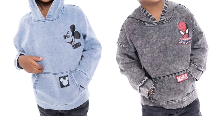 two boys wearing blue mickey and gray spiderman hoodies