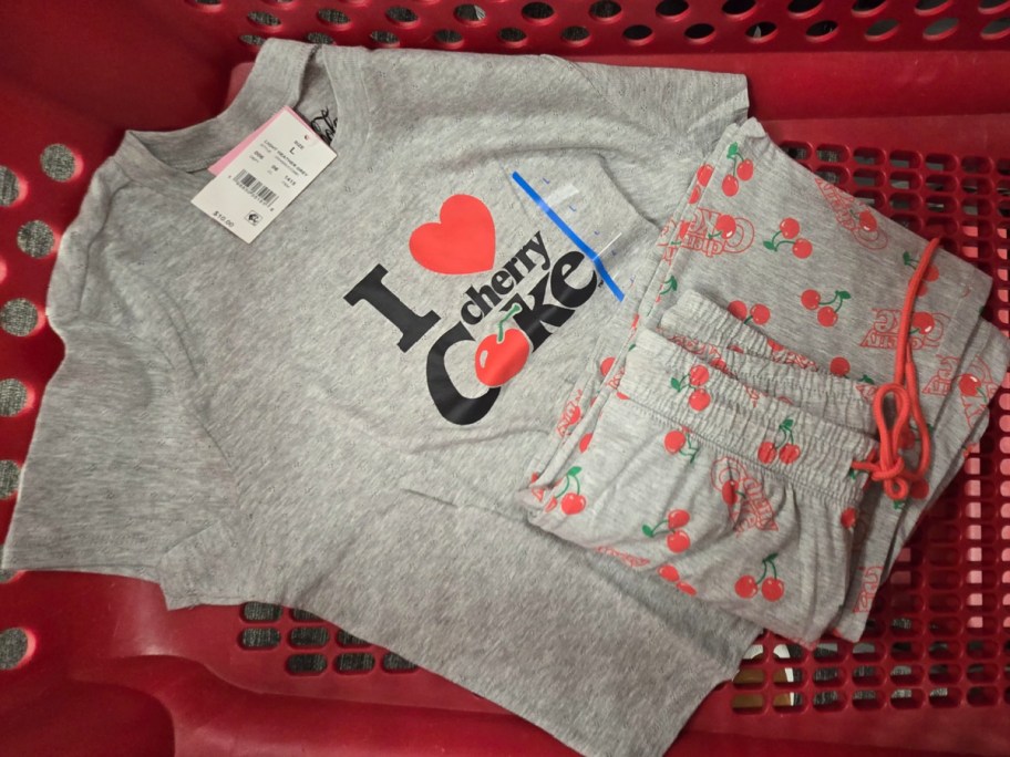 woman cherry coke shirt and women pants displayed in target cart