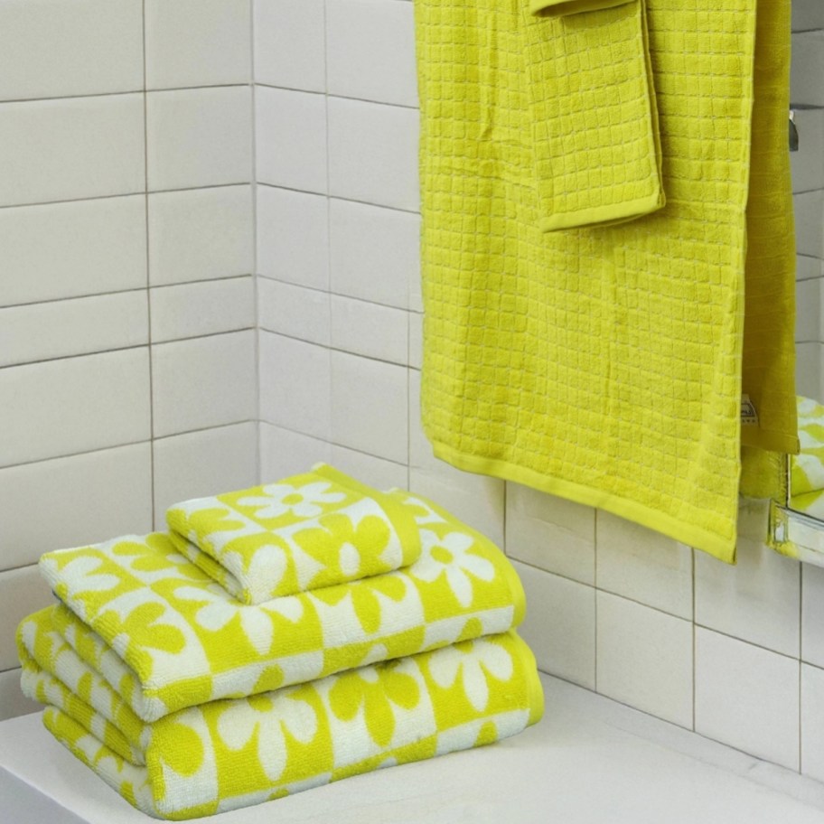 a 6 piece towels set in yellow and white floral print with coordinating solid yellow towels