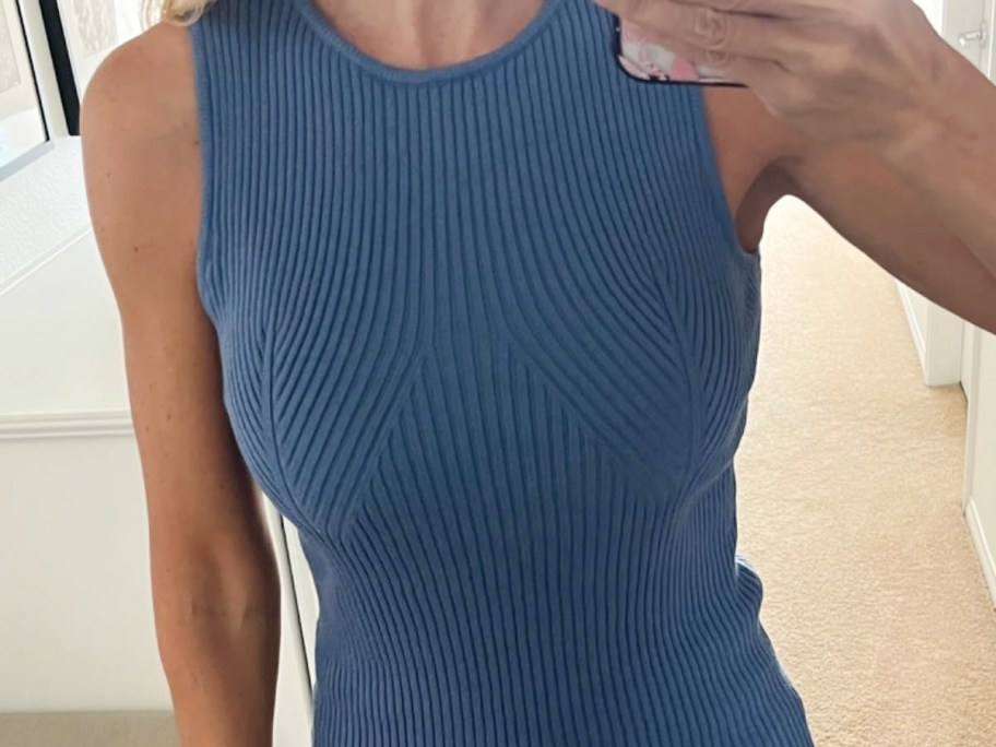 woman taking selfie in blue tank top
