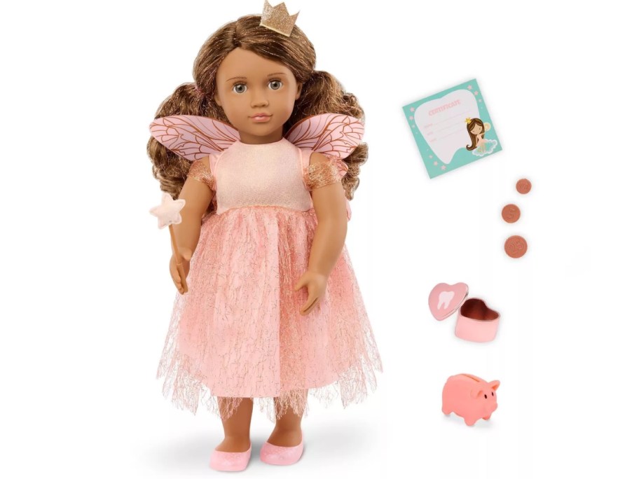 a doll dressed as the tooth fairy in a pink dress with accessories