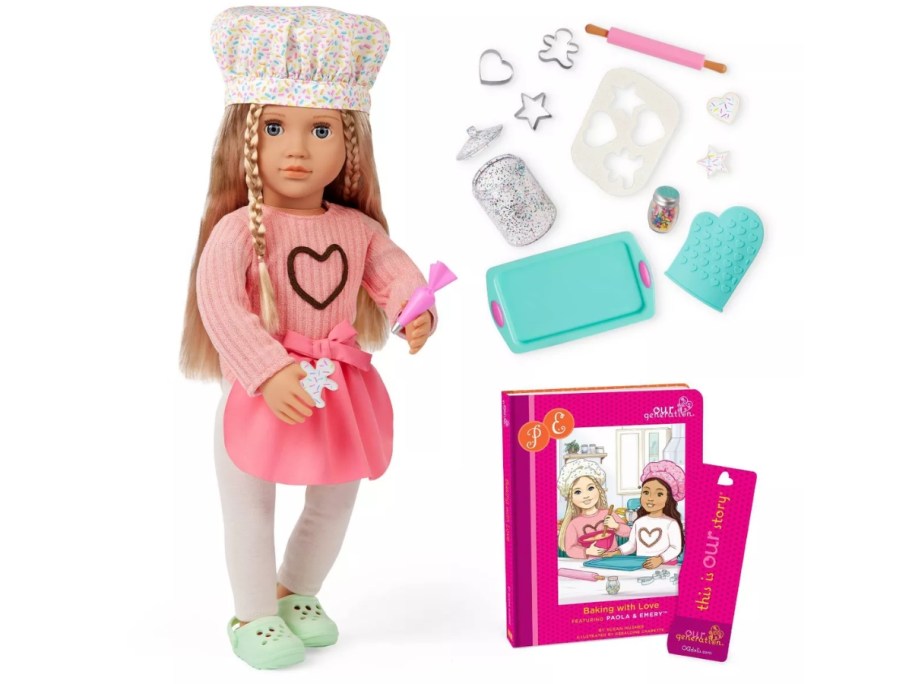 a doll with a chef's hat and apron next to baking toys