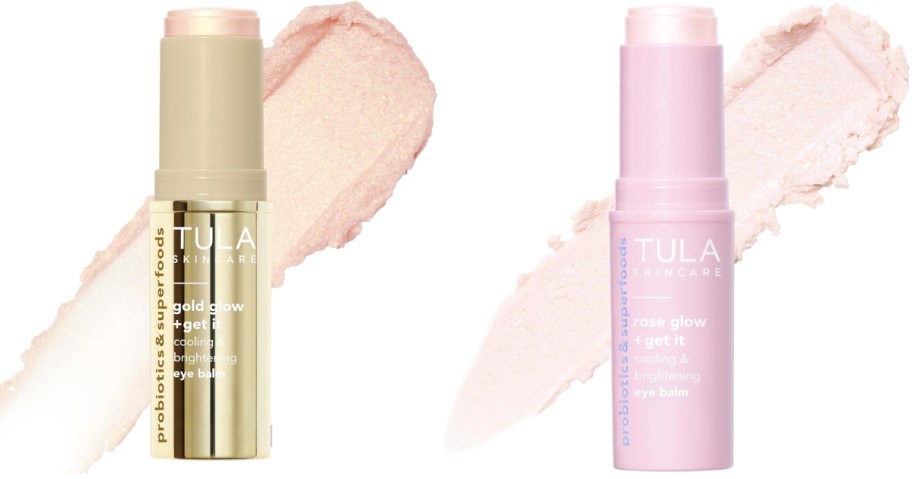 two TULA eye balm sticks with the cream spread out behind them