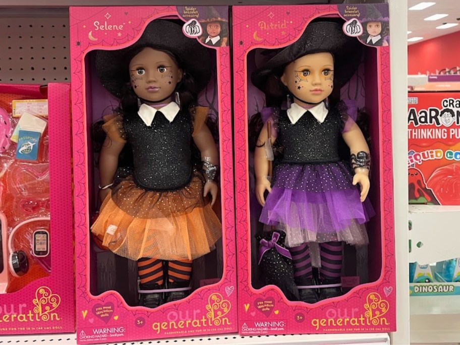 two Our Generation Halloween Dolls in boxes on a store shelf