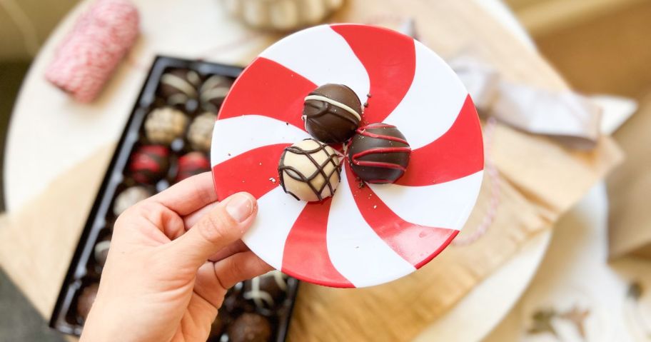 A box of Harry & David Chocolate Truffles and a red and white plate
