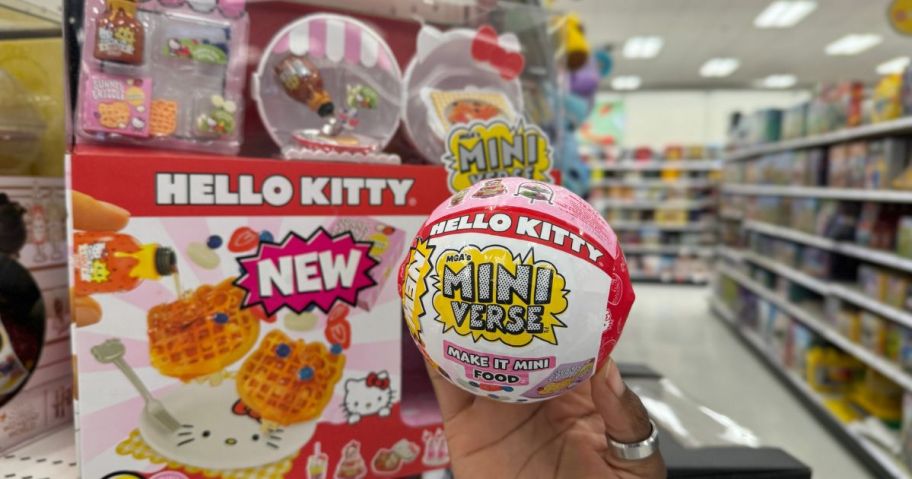 Hand holding a Hello Kitty Make 9it Mini MGA Miniverse Ball