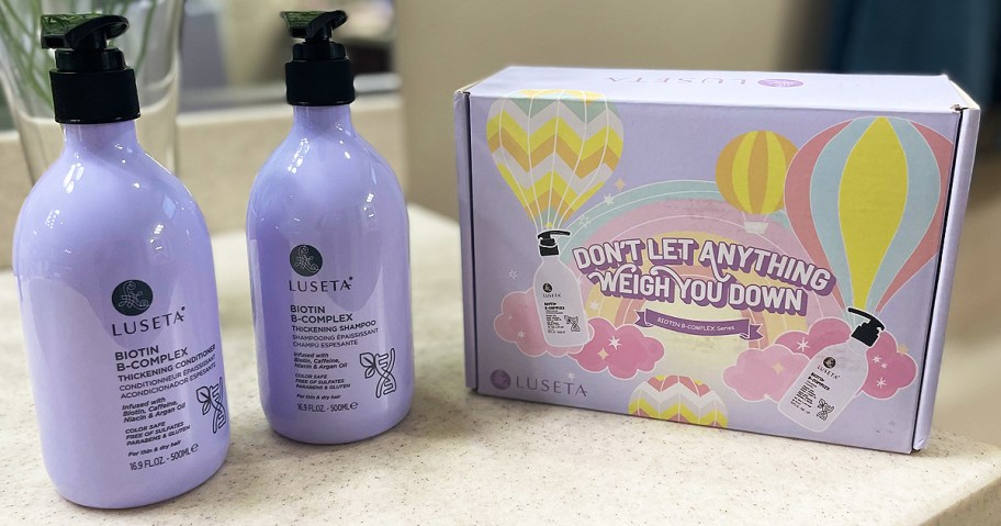luseta shampoo and conditioner in a puple bottle on a bathroom counter