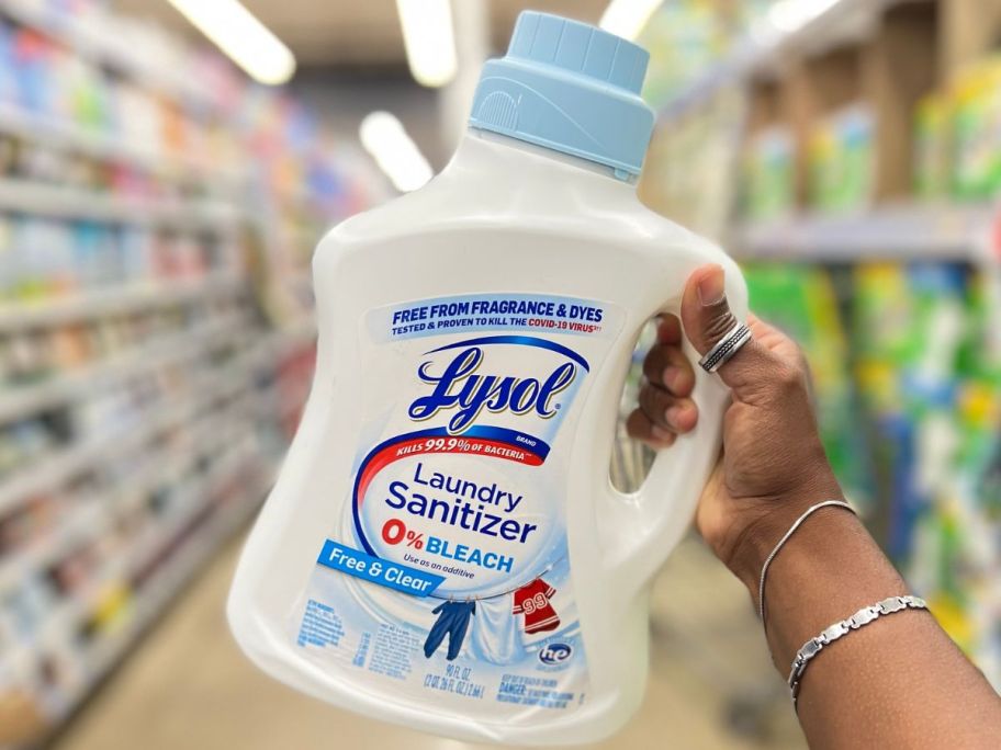 Hand holding up a bottle Lysol Free & Clear Laundry Sanitizer